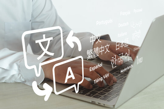 Man typing on laptop with translation icon and multiple languages text graphic. Concept of online translator, language learning app, global communication, localization and multilingual business.