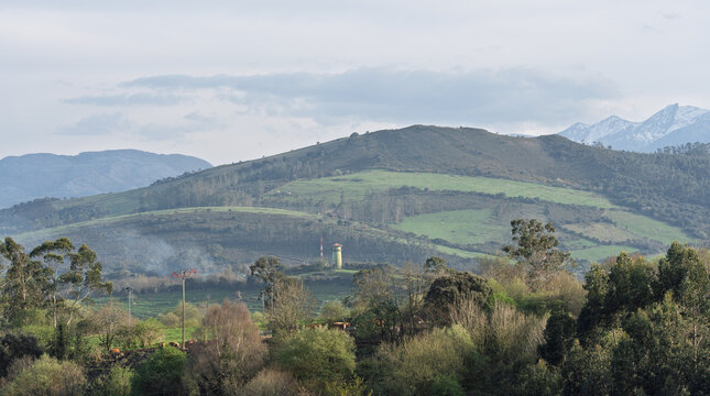 Green Hills and Distant Mountains in Peaceful Rural Landscape