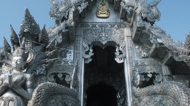 Entrance in Silver Temple Wat Sri Suphan in Chiang Mai, Thailand, covered with metal reliefs and traditional Buddhist ornament. Lanna art, Thai craftsmanship, sacred architecture, cultural tourism