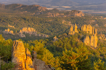 Obraz premium Belogradchik Rocks in Bulgaria, a spectacular natural rock formation featuring towering red sandstone and conglomerate cliffs shaped by erosion. The dramatic rock landscape