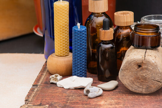 Beeswax Candle and Essential Oil Bottle. Aromatherapy Still Life with Candles and Bottles.
