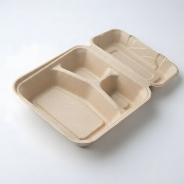 Empty biodegradable paper lunch box with three separate compartments isolated on a clean white background studio