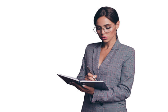 Portrait of her she nice cute attractive lovely sweet focused smart clever intelligent lady wearing gray checkered blazer writing daily plan isolated over maroon burgundy marsala background