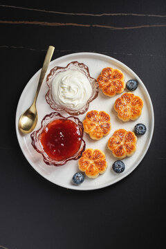 Cottage cheese pancakes, syrniki, curd fritters decorated with strawberry and raspberry served on a white plate. Homemade breakfast concept