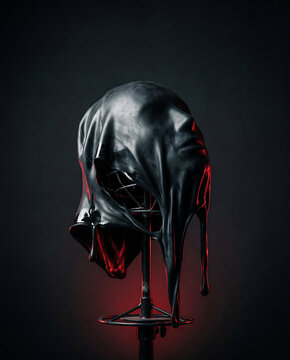Melting featureless latex face on stand, dark studio