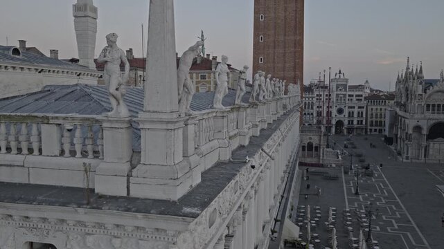 Aerial view of statues on the roof of a building in Italy.