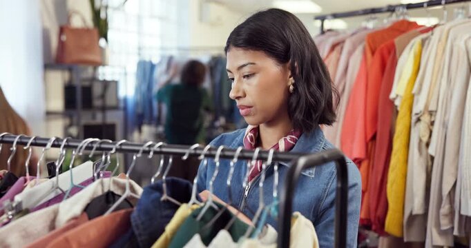 Shopping, search and woman in store with clothes, outfit review and decision in trendy style. Retail, check and customer in boutique with apparel rack, garment choice and option for fashion purchase.