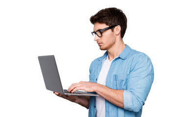 Half face, profile portrait of attractive, busy, stylish man in jeans shirt having laptop in arms, checking email, making presentation, searching information, isolated on grey background © deagreez