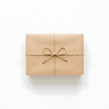 Brown paper gift box wrapped with rustic twine bow isolated on a clean white studio background