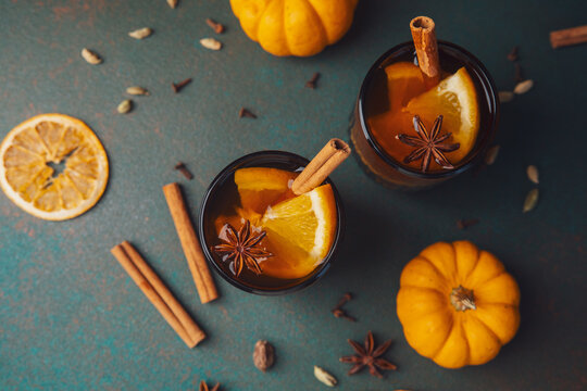 Autumn citrus drinks with cinnamon and star anise spices viewed from above