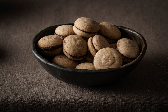 'Baci di dama', shot from the front to highlight their shape and the thin layer of chocolate cream that joins the two halves.