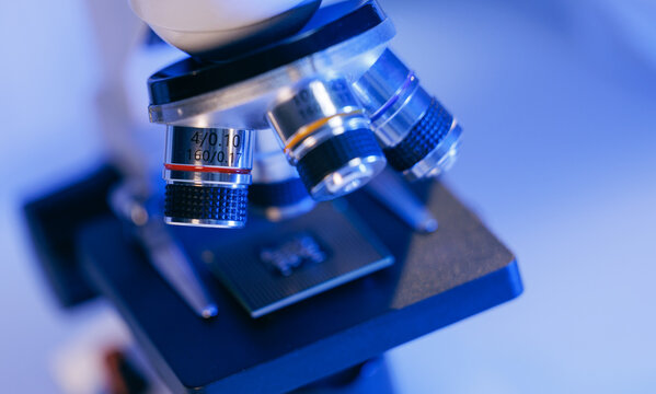 Microscope objective focusing on microchip in Laboratory artificial intelligence data center