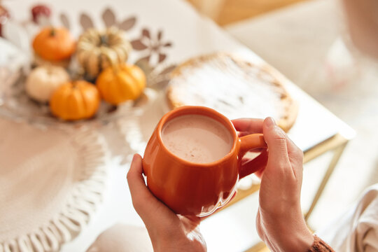 Cozy autumn morning with coffee and mini pumpkins.