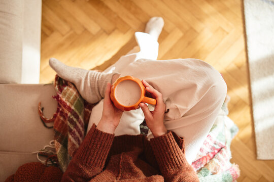 Cozy moment with a warm mug at home.