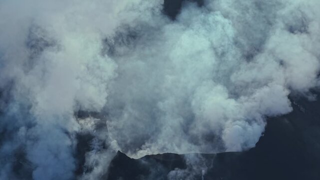 Aerial view of Stromboli volcano crater emitting thick smoke, Italy.