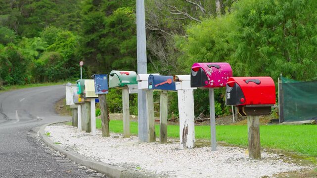 A row of colorful mailboxes by the roadside