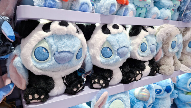 cute disney stitch plush doll wearing panda costume sitting on retail shelf on September 16, 2026 in Bangkok, Thailand.