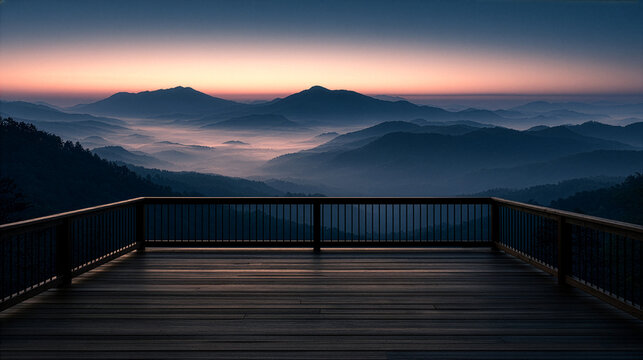 a wooden deck overlooking misty mountains before sunrise