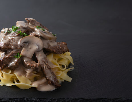 Beef stroganoff with beef strips and creamy mushroom gravy on pasta