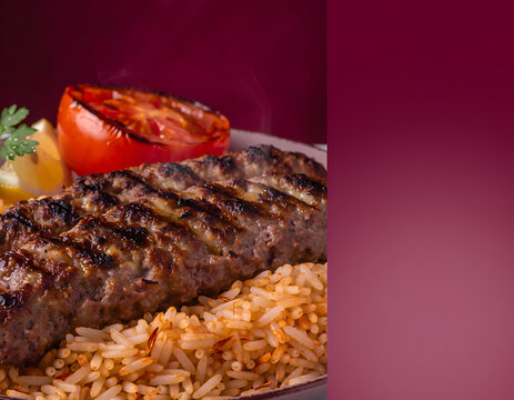 Iranian chelo kabab with grilled tomato and saffron rice