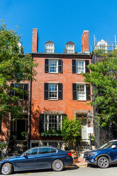Boston brick townhouse on city street with blue sky