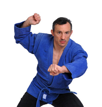 Martial arts fighter wearing blue kimono isolated on transparent layered background.