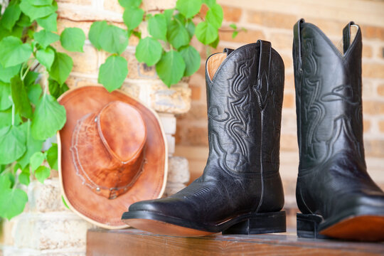 Close-up of a leather hat and cowboy boots