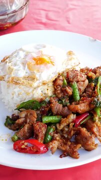 Thai Stir-Fried meet with Red Curry Paste Served Over Rice with Fried Egg