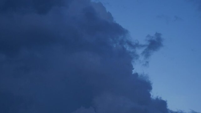 Dramatic Cumulus Clouds with Sunlight Breaking Through Blue Sky