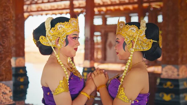 Profile View of Two Dancers Facing Each Other with Golden Crowns