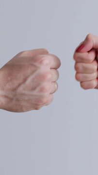 Vertical video. Fist to fist commit solidarity a respect gesture. Lifestyle business team hands fists close-up. Business concept of teamwork.