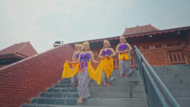 Low Angle View of Dancers Walking Down Stone Steps in Formation