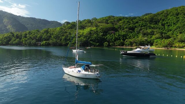 Calm green lagoon with sailing boats on the island of Ilha Grande, Brazil