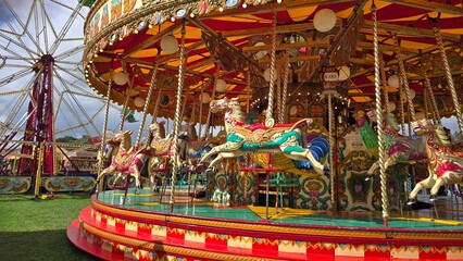 Colorful Vintage Carousel With Painted Horses At Outdoor Fairground During Festival © Angela Harburn