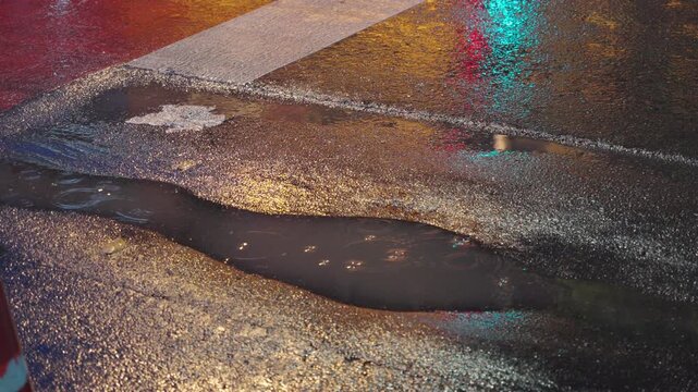 Puddle reflection on a rainy Bangkok road