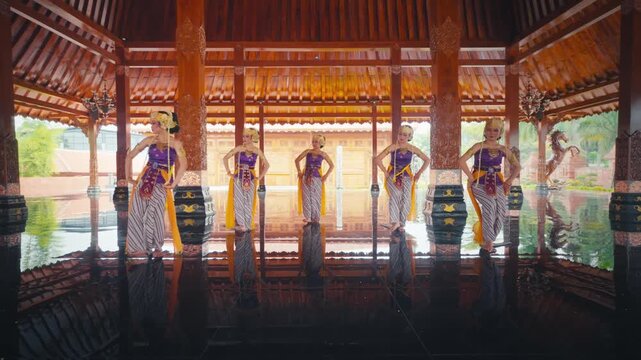 Wide Shot of Dancers Standing in Line Holding Yellow Sashes in Hall
