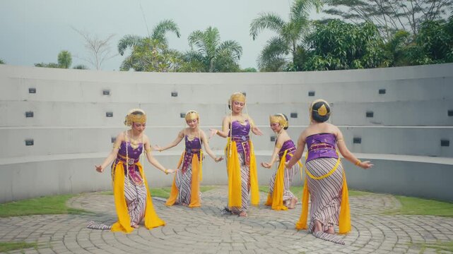 Dancers Spreading Yellow Sashes in Circular Outdoor Formation