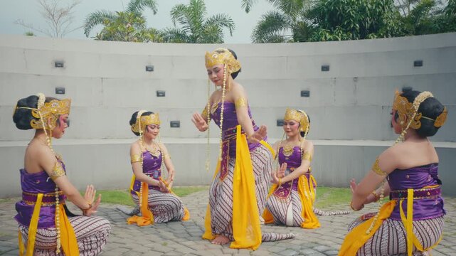Cultural Dance Formation with Lead Dancer Standing and Troupe Kneeling