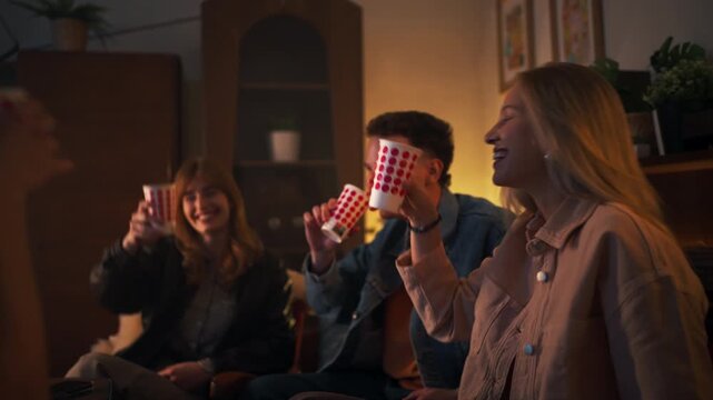 Group Shares Jokes And Tasty Treats. Friends Gather To Enjoy Laughter And Delicious Snacks
