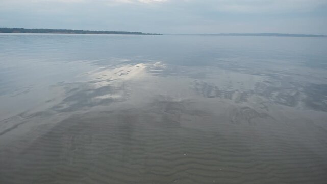 Surface of the calm river during overcast day
