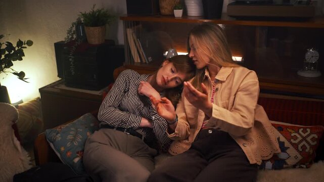 Young women having a serious conversation and support in a cozy apartment