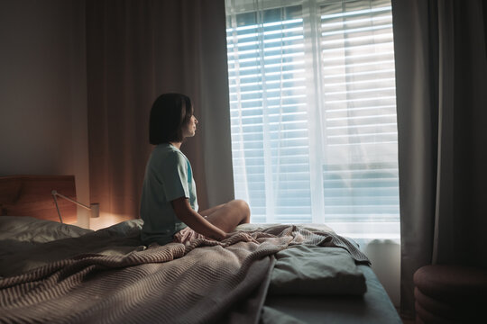 Gentle Woman Gazing At Sunlight Through Window, Serene Lady Contemplating Daylight From Her Bedroom Window
