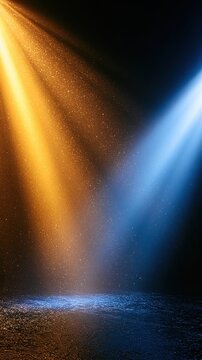 Dramatic orange and blue stage spotlight beams with atmospheric particles for background and poster design