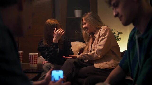Friendship Whispers Shared. Women Engaging In Confidential Talk Illuminated By Gentle Lamp Glow