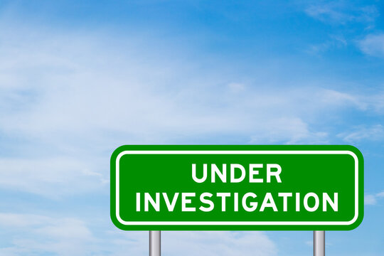 Green color transportation sign with word under investigation on blue sky with white cloud background