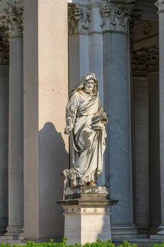 Marble statue of Saint Luke the Evangelist with winged bull in Quadriportico at Basilica of Saint Paul Outside the Walls, Rome landmark