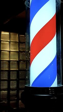 Barber shop pole spinning with glass blocks in the background