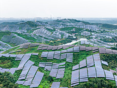 solar power station panels arranged on rolling green hills