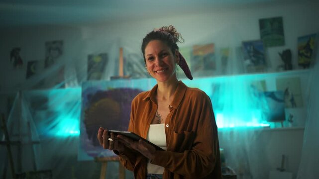 Artist With Palette In Bright Studio. Creative Artist Smiling Among Colorful Artwork