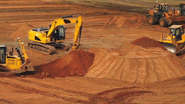 Heavy Excavators and Bulldozers Earthmoving on Construction Site